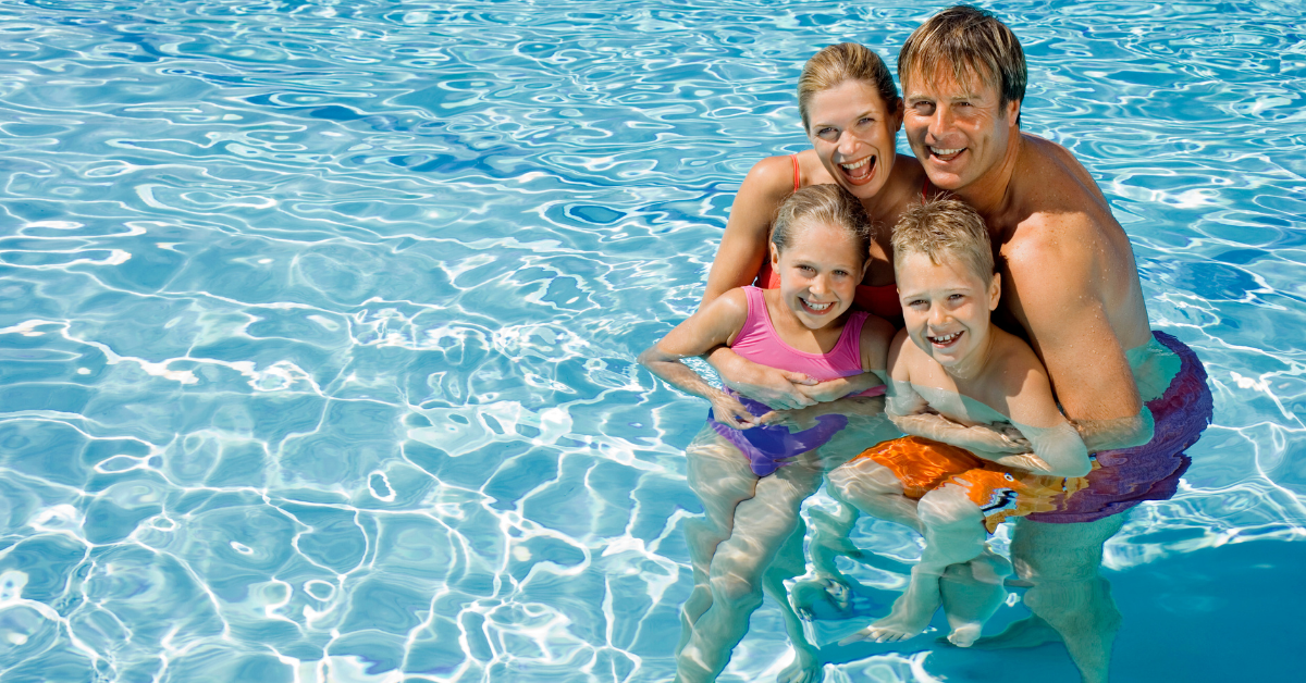 family having dun in the pool community pool inside Palm Drive Estates